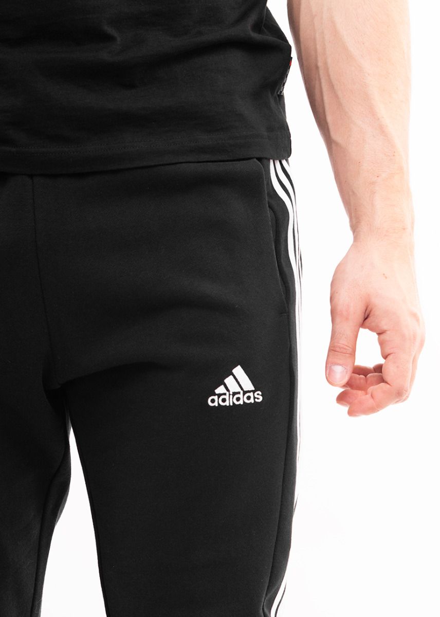 adidas Spodnie męskie Essentials French Terry Tapered Cuff 3-Stripes HA4337